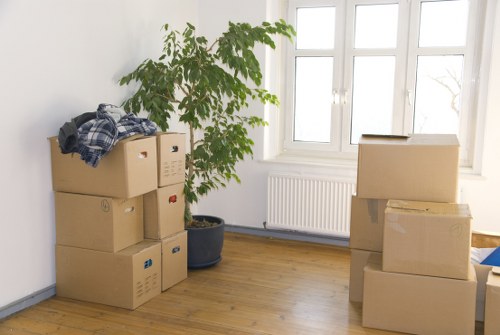 Packed moving boxes and wrapped furniture ready for local transport