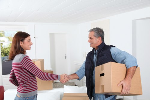 Local removals team unloading household items into a new home in Colliers Wood