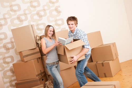 Removal team moving furniture through a Colliers Wood property